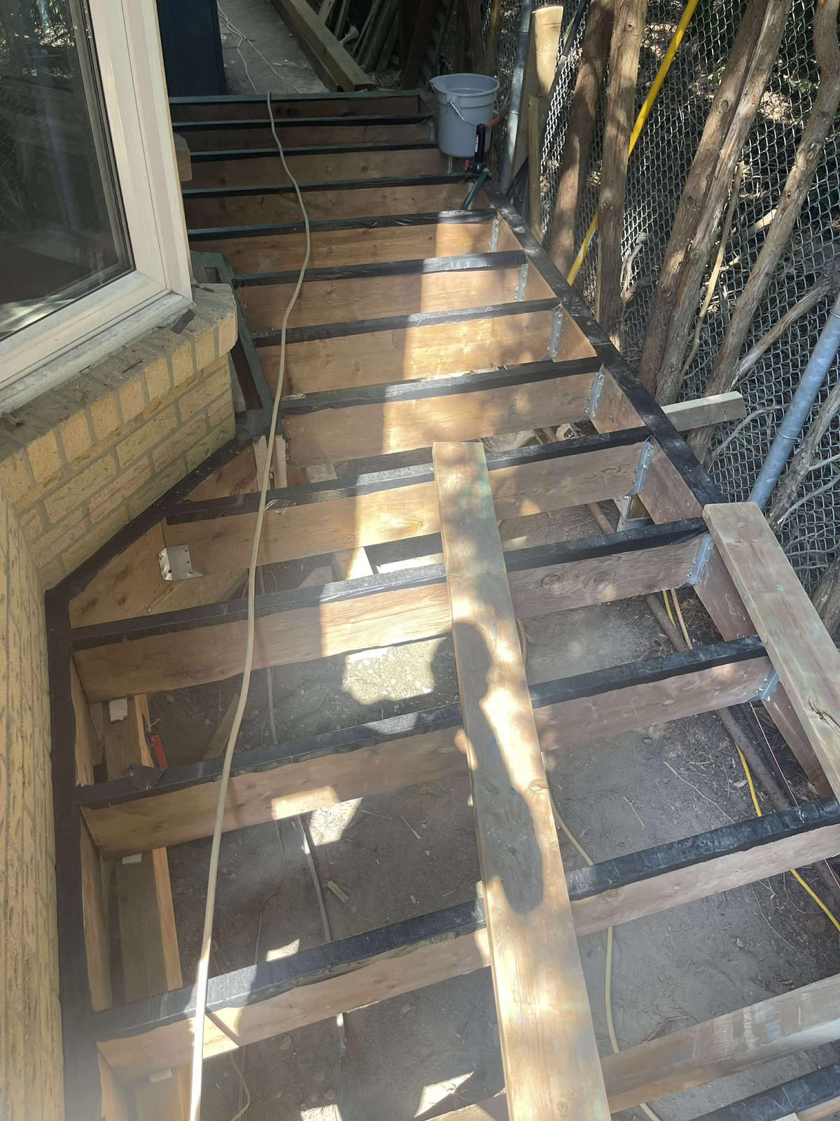 Walkway framing between house and pool during construction