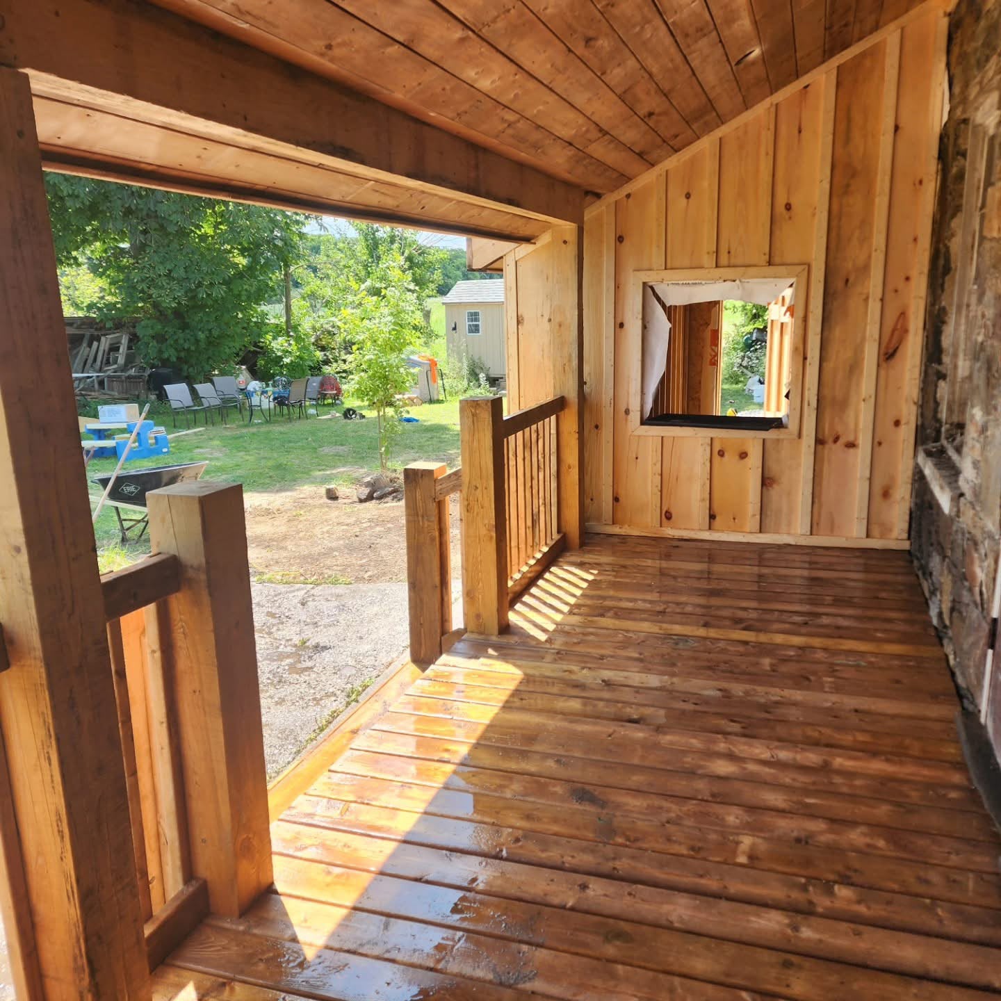 Interior of the restored porch with cedar cladding and refinished plank floor